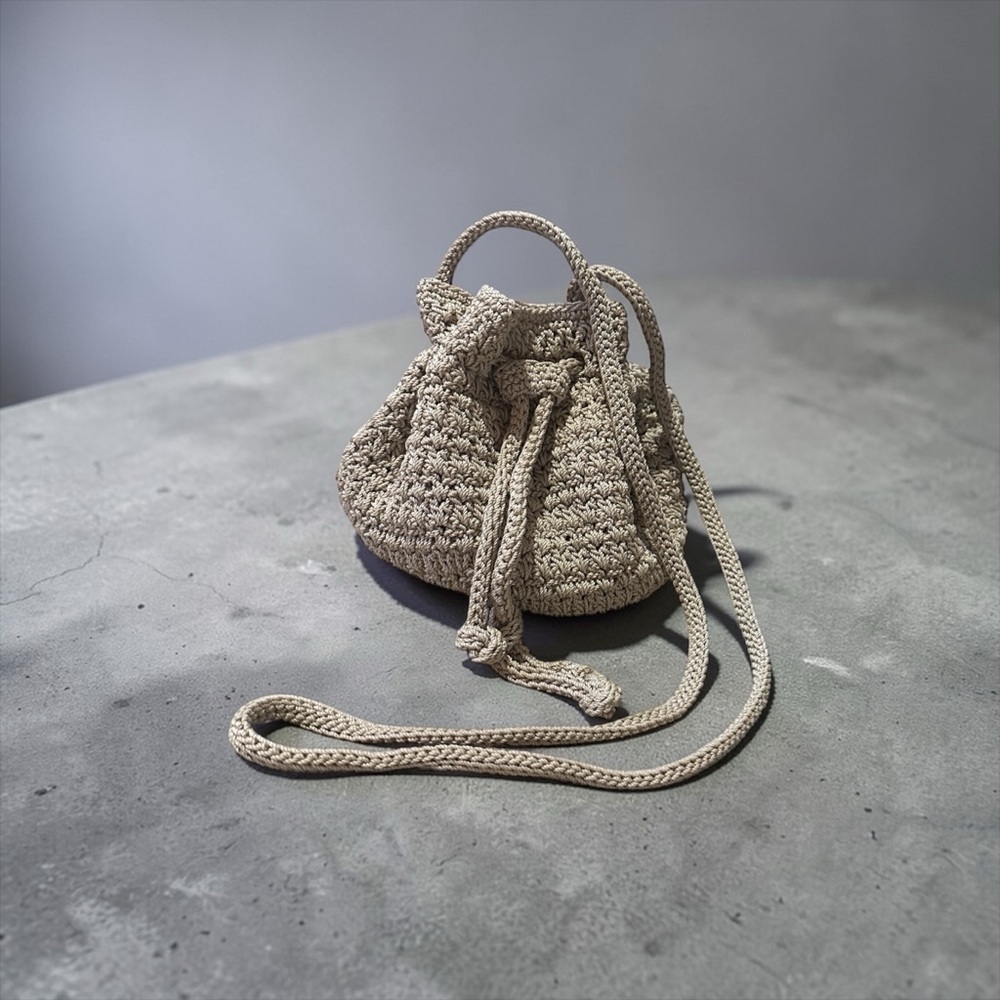 The Sak Crochet Crossbody Bucket Bag Floral Lining Draw Pull Closure Beige